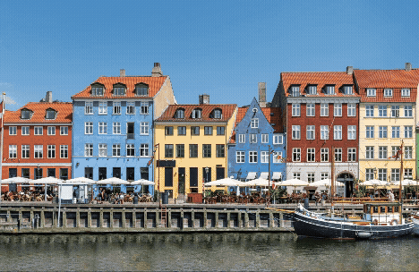 A picturesque waterfront scene featuring colorful buildings and a boat.