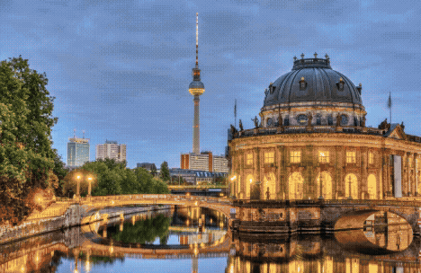 A scenic view of the Bode Museum with the Berlin TV Tower in the background during twilight.