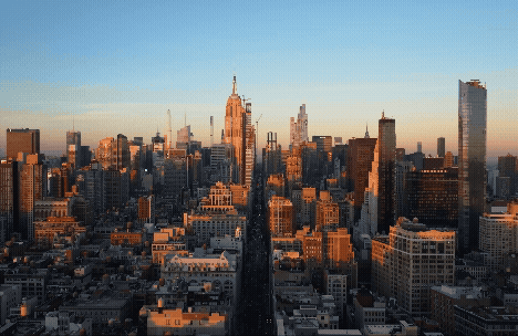 A breathtaking skyline view of a city at sunset with tall buildings and a clear sky.