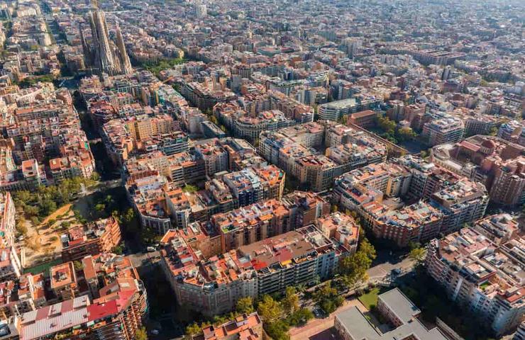 Aerial view of a densely populated city with distinct architecture near the coastline.