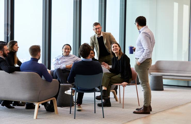 A group of professionals having a meeting in a modern office setting.