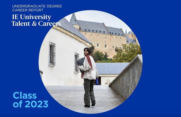 A young woman walks on a campus with historical buildings in the background, featured on a promotional cover for IE University's Career Report for the Class of 2023.