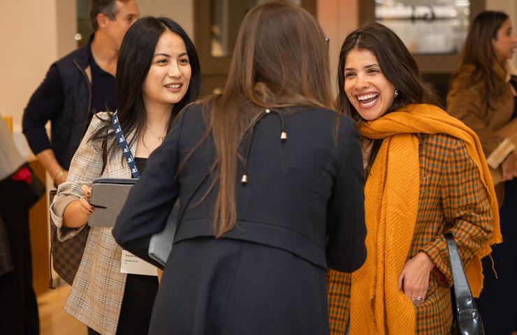 A group of women engaging in a lively conversation at an event.