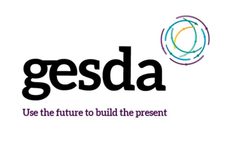 Logo of GESDA featuring a modern design with multicolored swirl and the slogan 'Use the future to build the present'.