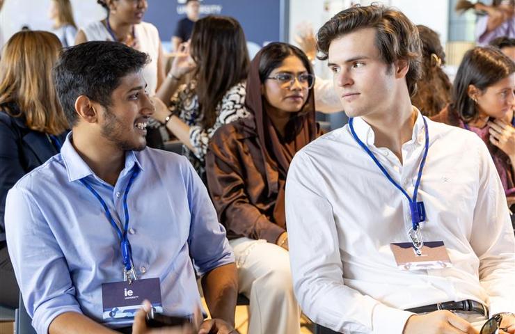 A diverse group of people engaged in conversation at an event.