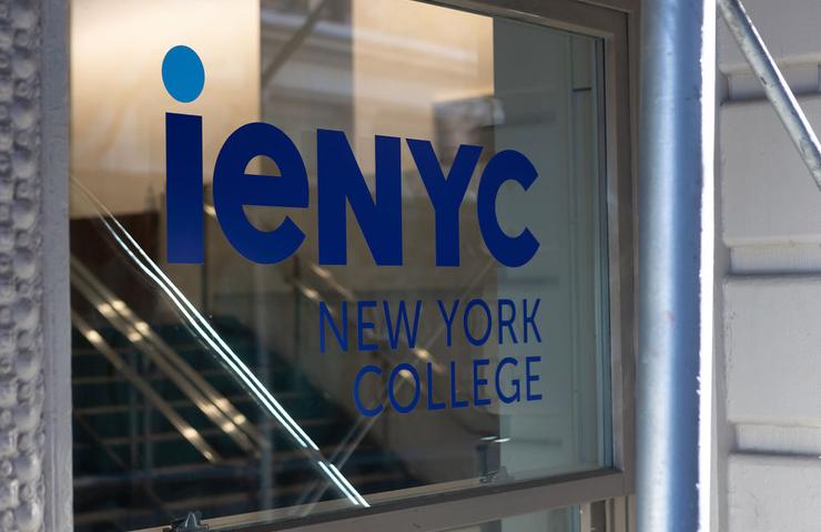 A sign displaying the name of a college in New York.