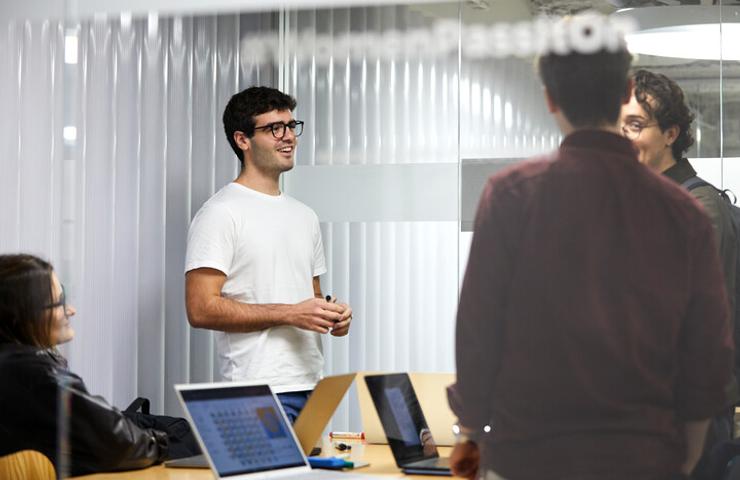 A group of people involved in a discussion in a modern office environment