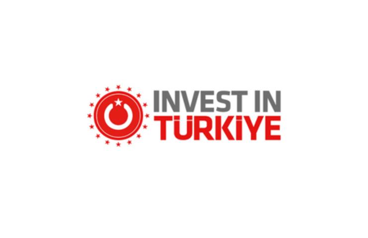 Logo of 'Invest in Türkiye' featuring a red and white color scheme with a circular design and a crescent moon symbol.