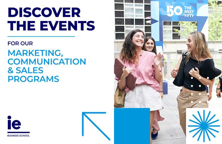 Three women happily engaged in an outdoor event at a business school.