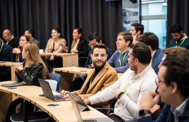 A group of people attending a meeting in a modern conference room.