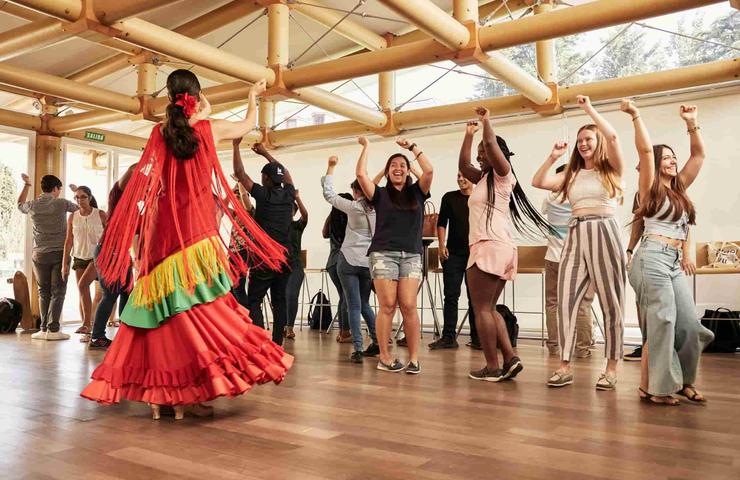 A group of people enjoying a dance performance in a lively setting.