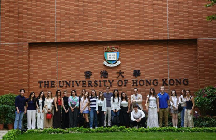 A group of students posing in front of the University of Hong Kong.