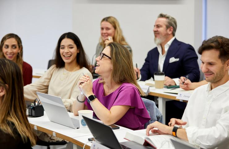 A diverse group of people engaged in a lively discussion during a class.