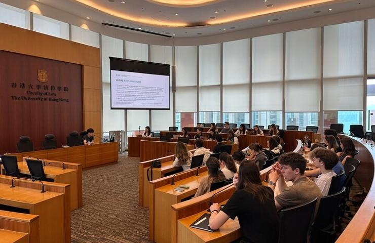 A group of students engaged in a lecture in a university classroom.