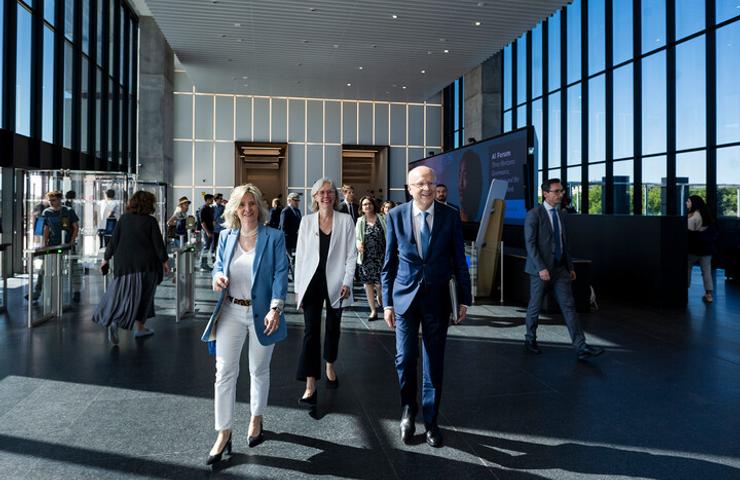 A group of professionals walking together in a modern building lobby.