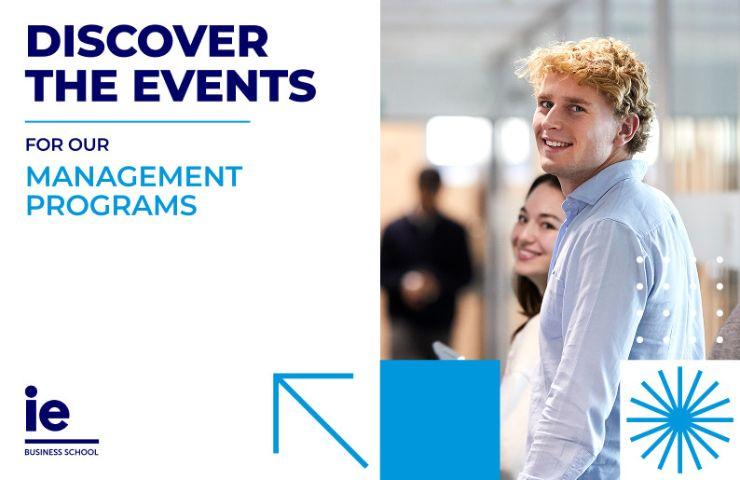 A cheerful student smiles while promoting management programs at a business school event.