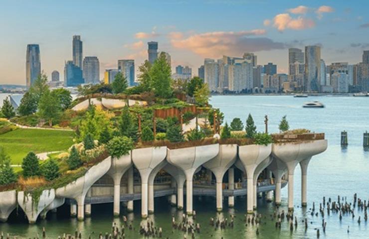 A scenic view of a modern park with lush greenery and a city skyline in the background.