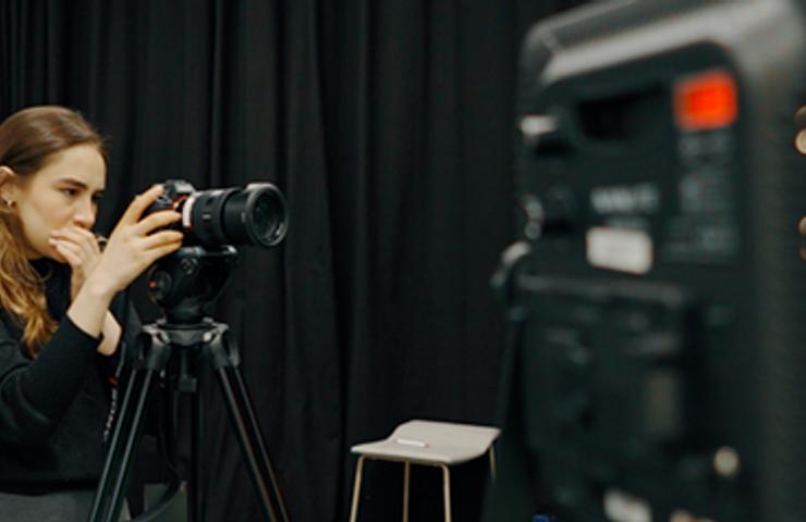 Woman with a professional camera in a film set