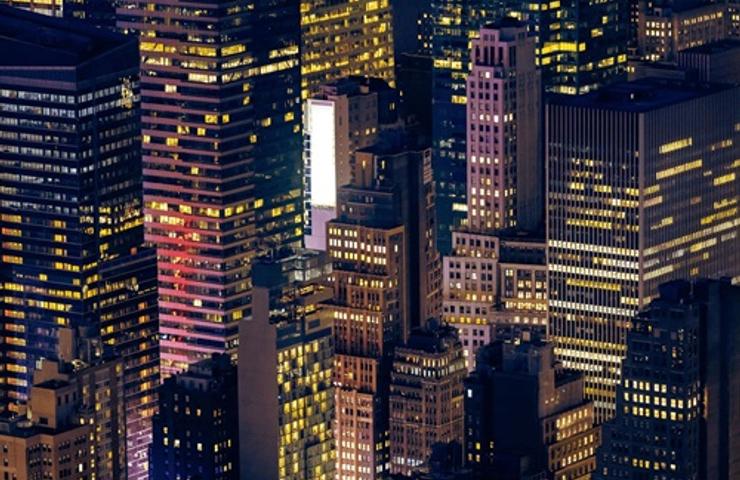 Aerial view of illuminated skyscrapers at night.