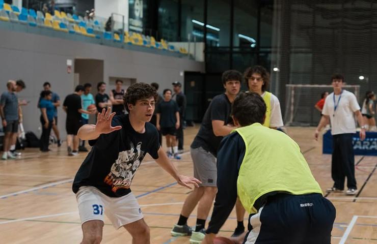 A group of young players engaged in a basketball training session.