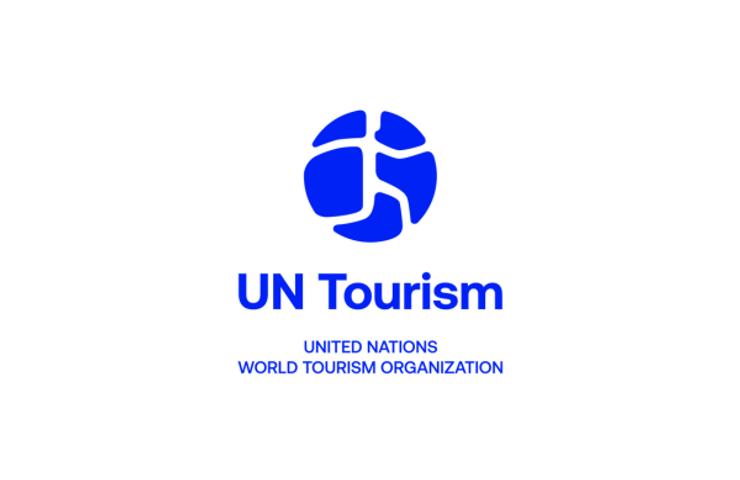 A logo representing UN Tourism with a globe icon and organization name.