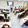 A group of students attending a presentation in a modern classroom.