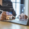 A person using a digital device with floating interface elements related to AI and ads.