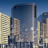A digital artwork of a futuristic cityscape overlaid with various technological and scientific diagrams.