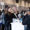 A group of people engaged in conversation at a professional event.
