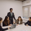 A group of professionals collaborating around a conference table in a modern office.