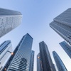 A view looking up at tall skyscrapers against a clear sky.