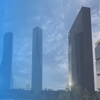 Modern skyscrapers under a blue sky with clouds, showcasing contemporary architecture.