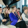 A group of adults attentively listening during a seminar.