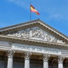 The facade of the Spanish Congress building with a flag flying above.