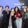 A group of six young adults are joyfully posing together at an event, with a background banner reading 'IE Foundation Fellows Winner Gathering December'.