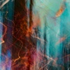 Abstract blurred motion of lights with a blend of blue, orange, and white colors creating a dynamic and artistic effect.