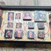 The image showcases a collection of paintings displayed on a tiled surface.