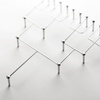 A minimalist metal structure composed of interconnected lines and rods.