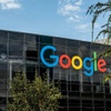 A modern building with the Google logo prominently displayed on its glass facade.