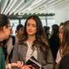 A group of young women engaged in a conversation at a social event.