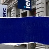 A street view showcasing a building facade with a blue and white sign that reads 'iemNYC'.