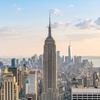 A panoramic view of a city skyline featuring the Empire State Building.