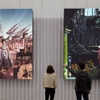 People loking some paintings at IE University School