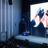The image depicts a graduation ceremony with students celebrating by tossing their caps in the air.