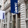 A street view of a building with flags displaying the logo of 'ieNYC'.