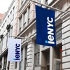 The image shows two flags displaying the logo 'ieNYC' outside a building.