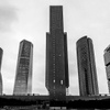 Black and white image of the five towers of the business center of Madrid (Spain) with the IE Tower in the middle