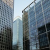 The image showcases a group of modern skyscrapers with reflective glass exteriors.
