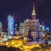 A stunning night view of Warsaw's skyline featuring modern skyscrapers and the Palace of Culture and Science.