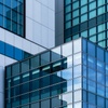 An abstract view of modern architectural glass and metal facades.